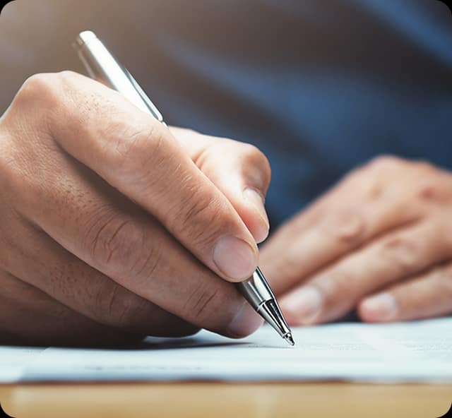 A hand preparing project documentation with a pen